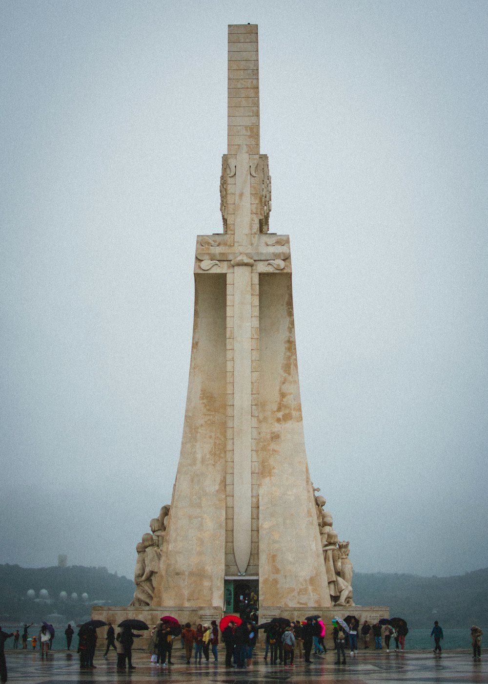 a group of people standing in front of a monument