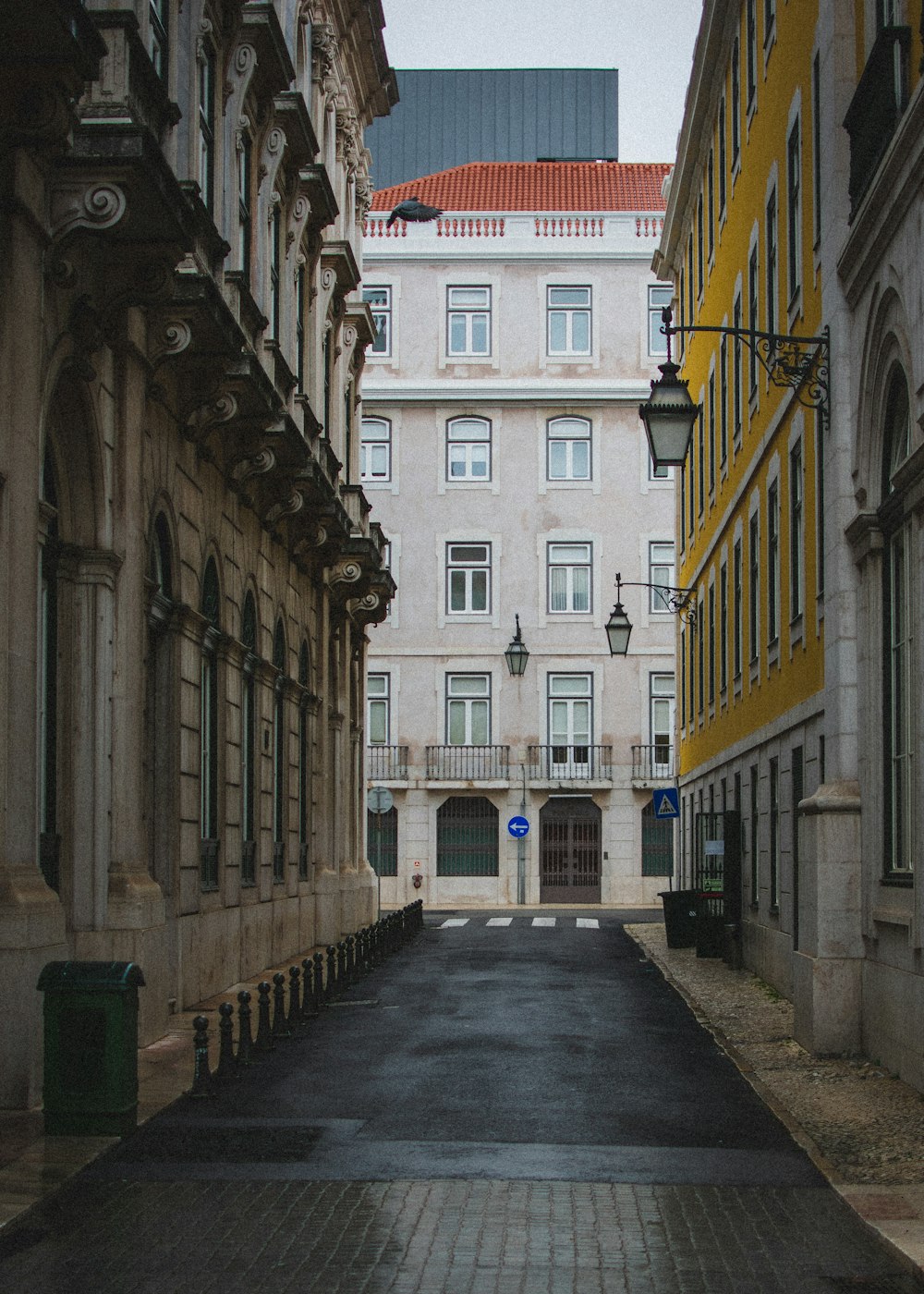 an empty street in a large city with tall buildings