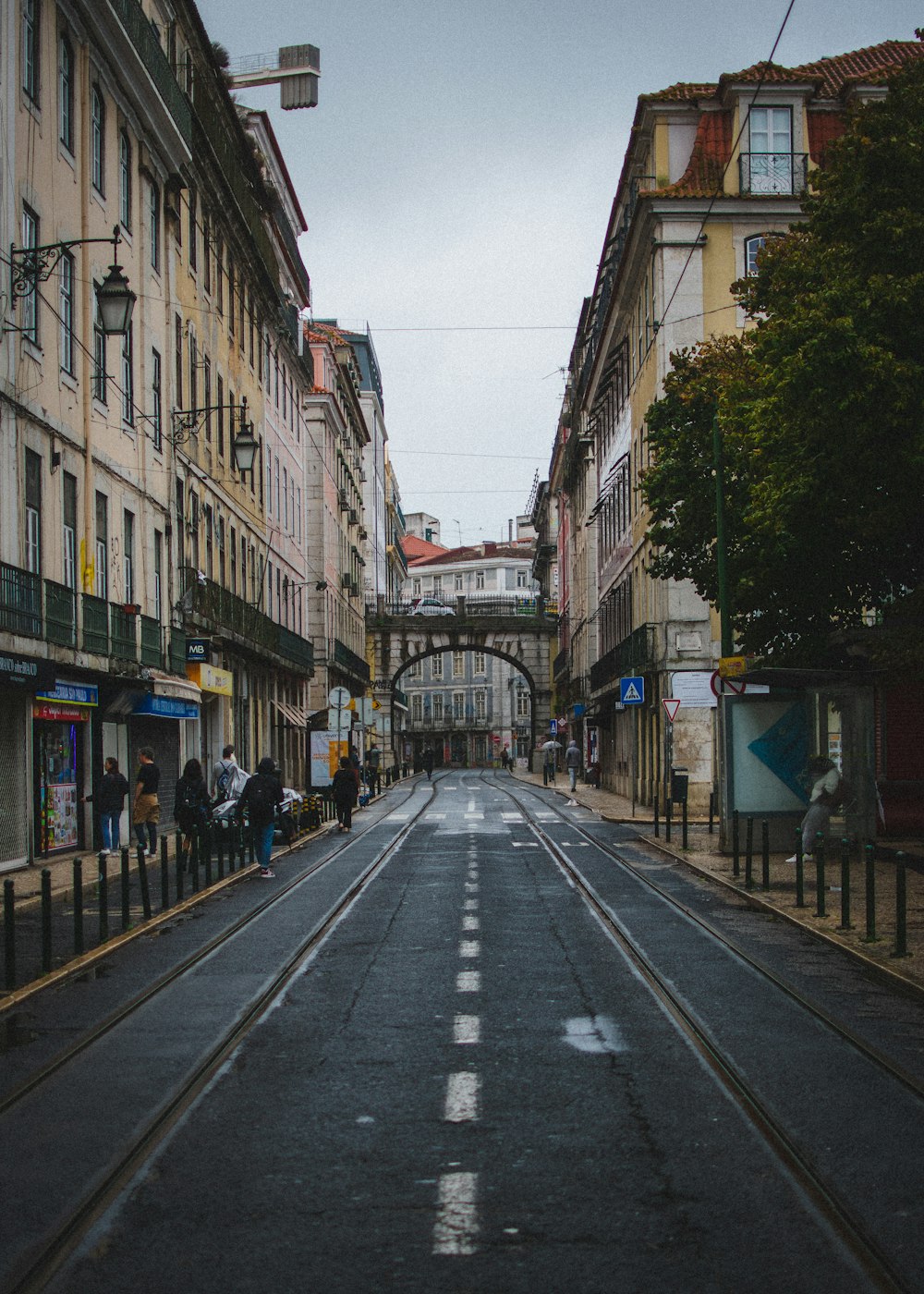 an empty street with a train track going through it