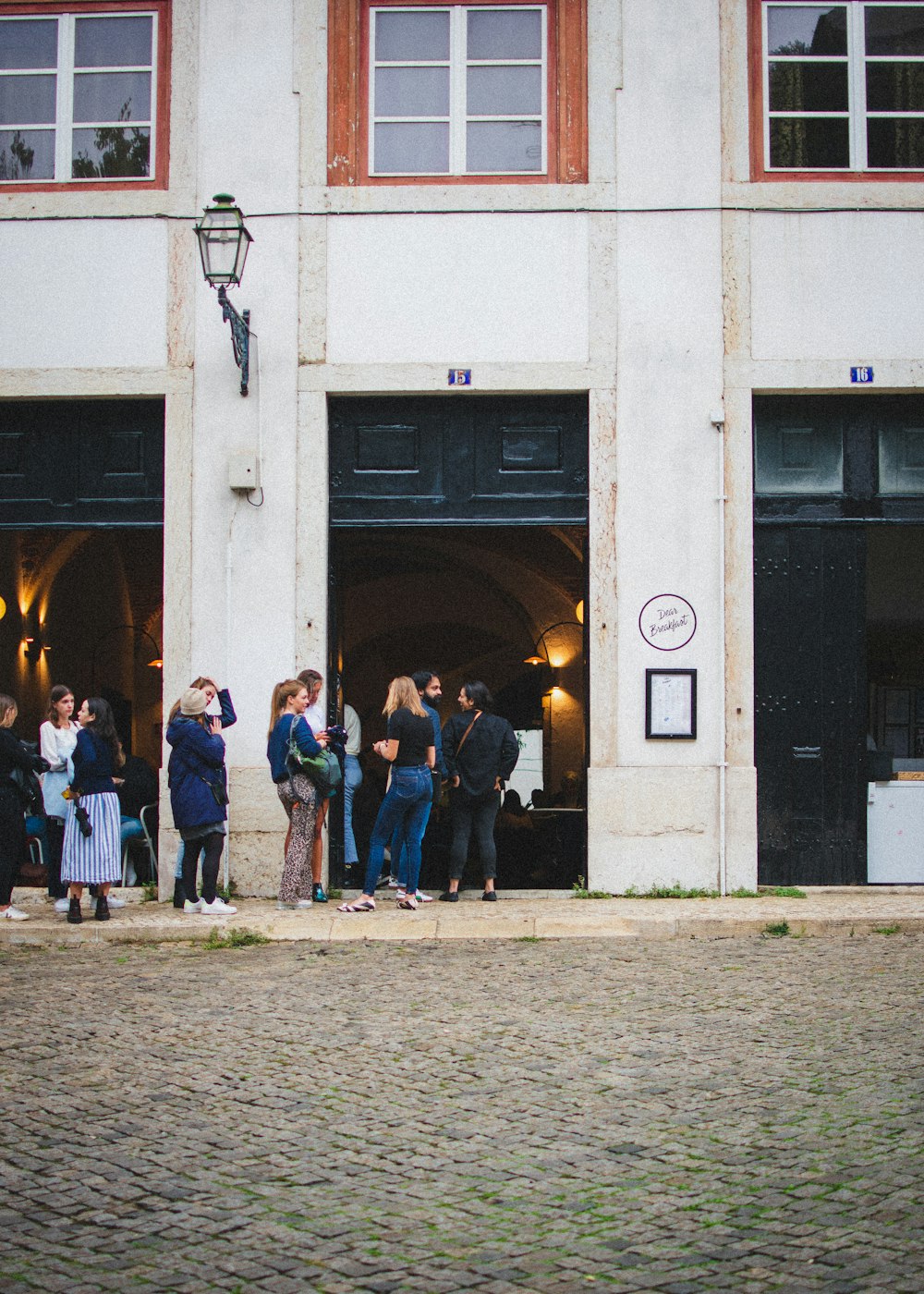 a group of people standing in front of a building