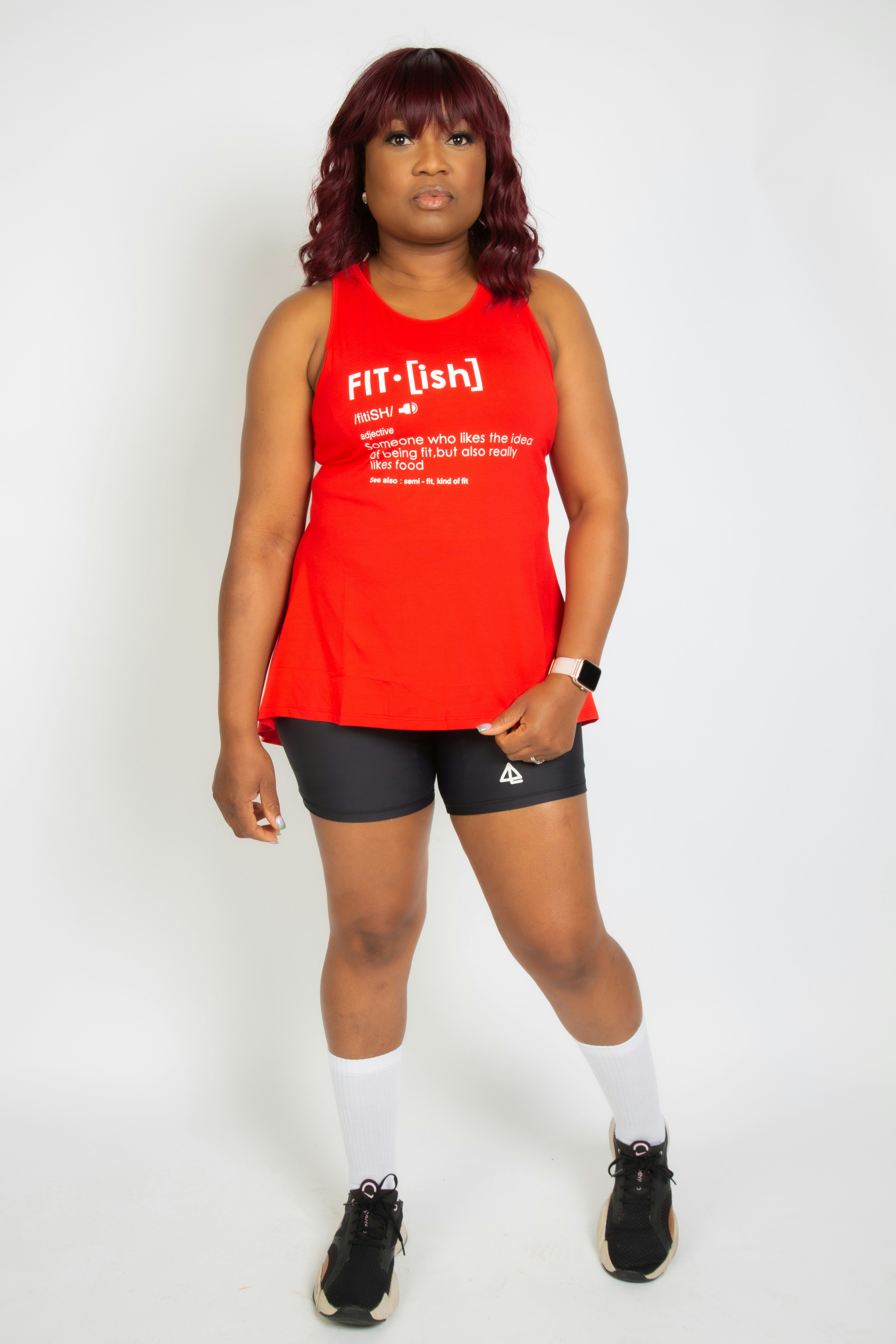 a woman in a red shirt and black shorts