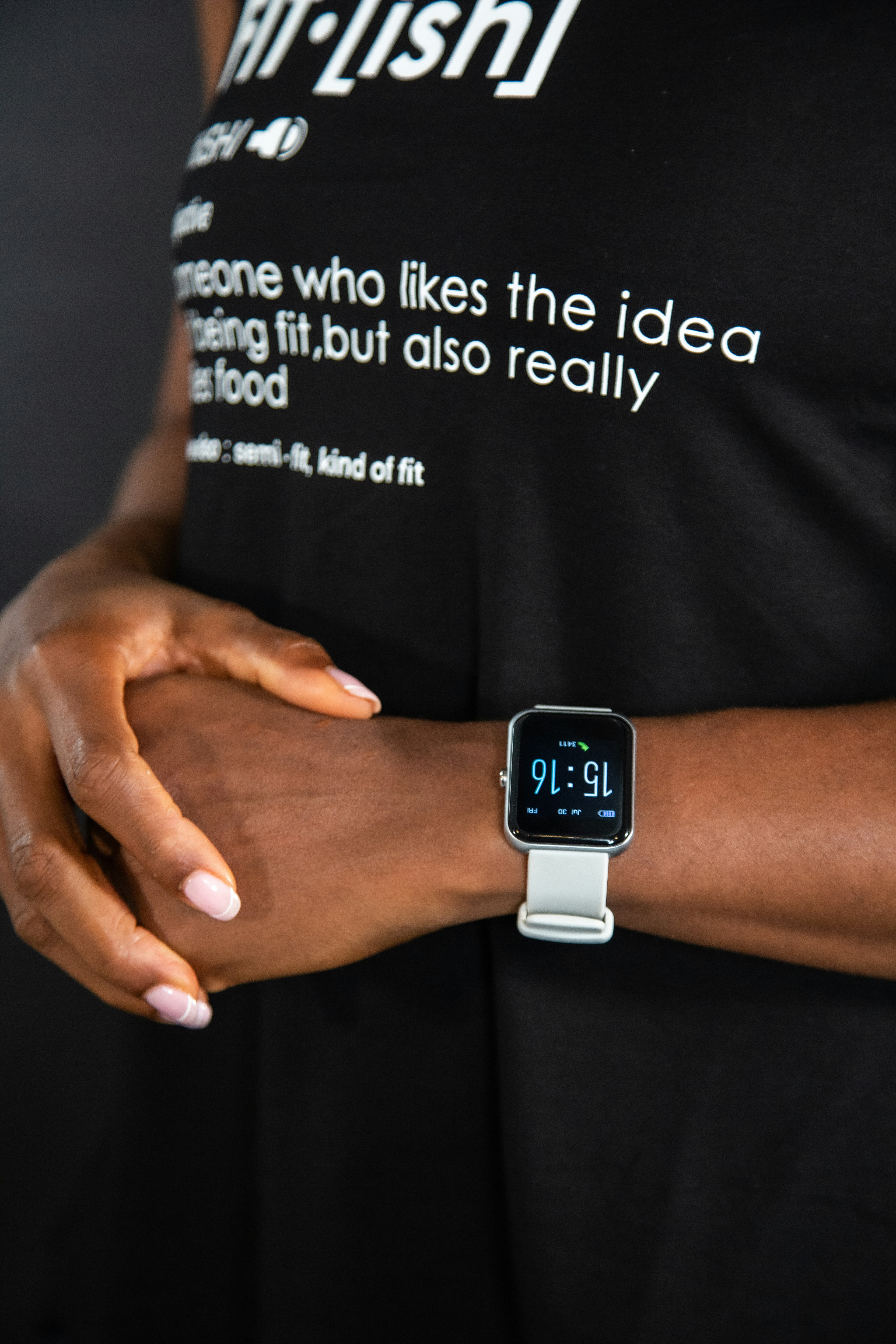 a woman wearing a black shirt and a white watch