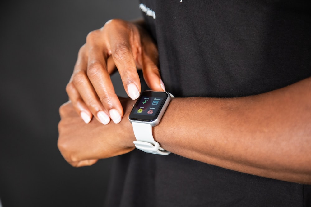 a close up of a person holding a smart watch