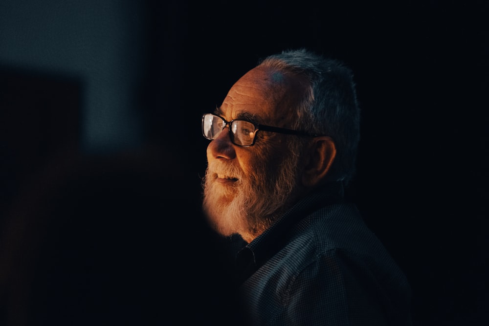 a man with glasses looking off into the distance