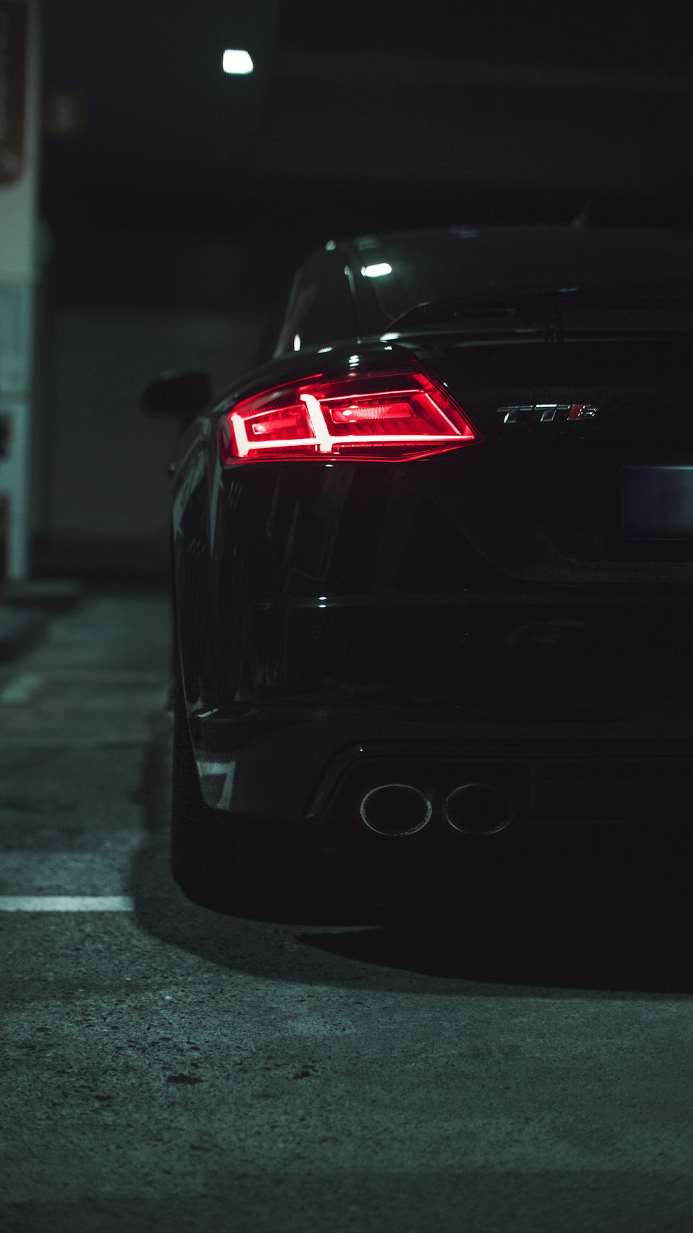 a car parked in a parking lot at night