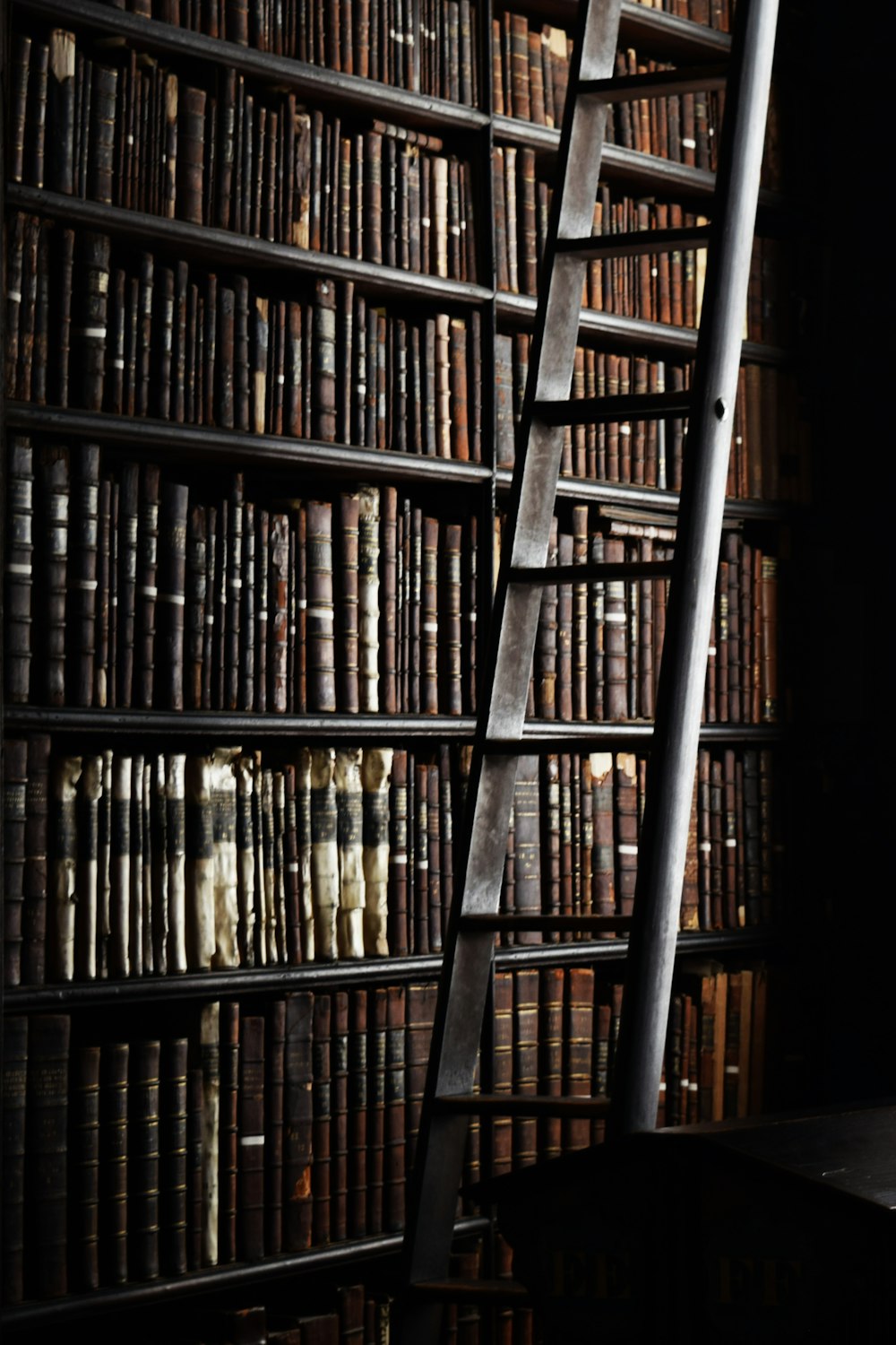 a ladder leaning against a bookshelf filled with books