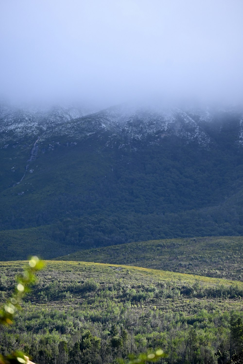 a view of a mountain range with snow on the top of it