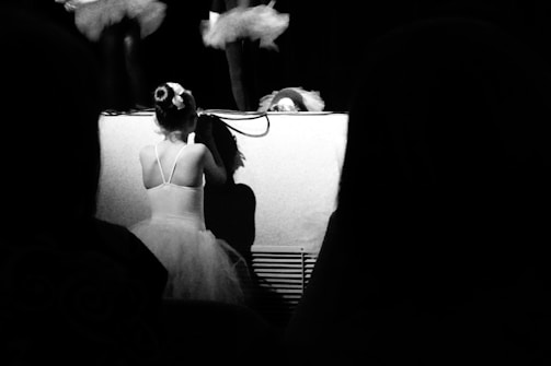 A close-up of a child confidently performing on stage during a small recital.