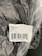 The image displays a plastic packaging containing a product labelled with a barcode sticker. The label includes text and numbers, specifically indicating '45MB3023 PANTS UFH 27' along with a barcode and a number below it.