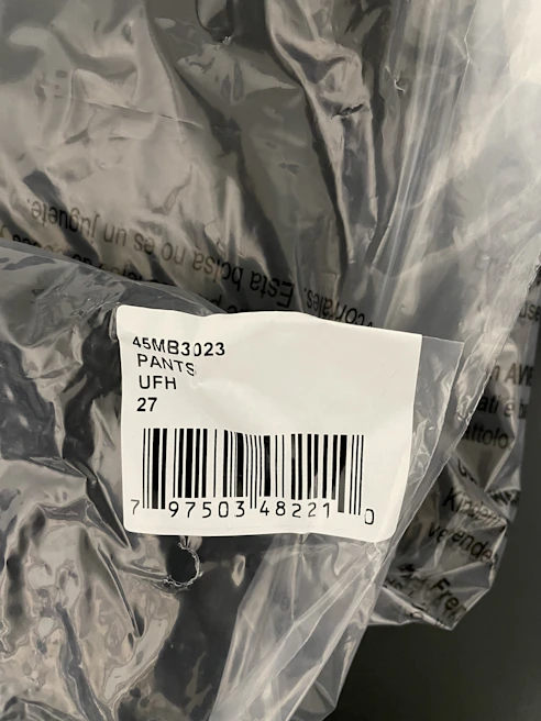 Barcode adhesive labels applied on product packaging in a retail setting