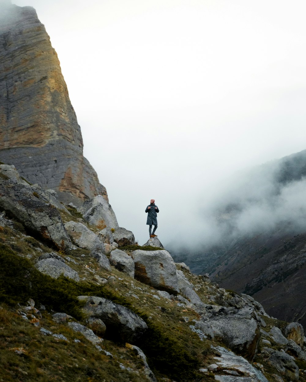 a man standing on top of a rocky mountain