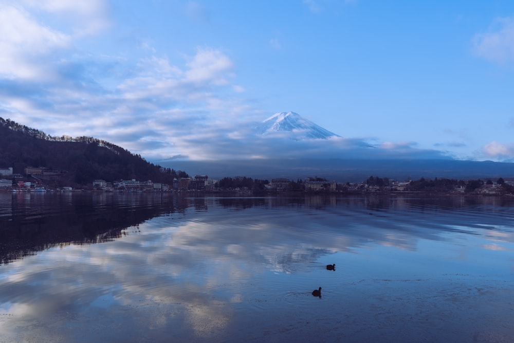 a large body of water with a mountain in the background