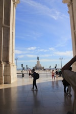 Famous Mexican landmark with tourists taking photos on a sunny day.