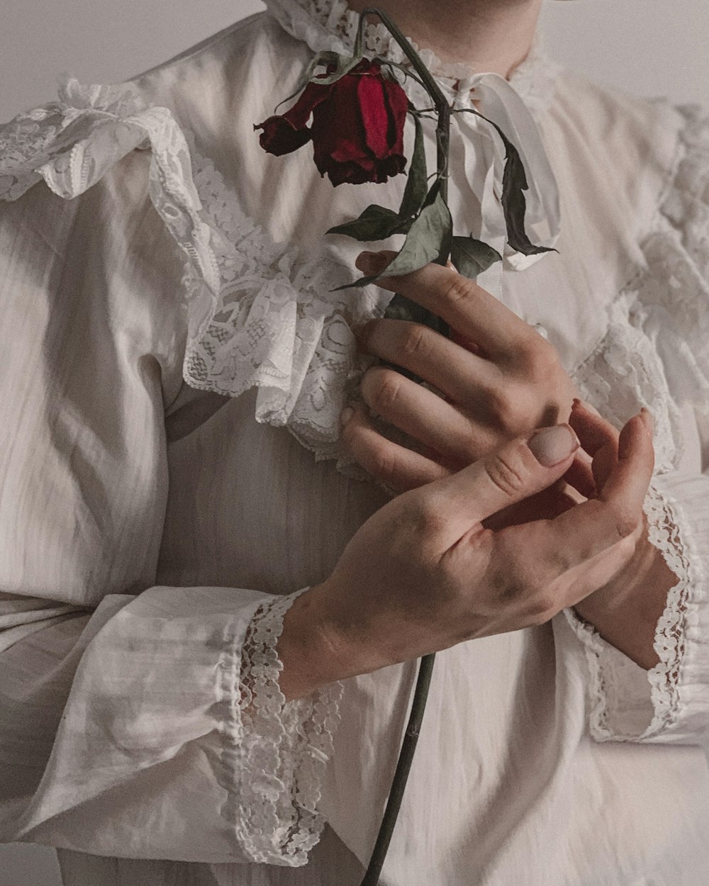 a woman with a rose in her hand
