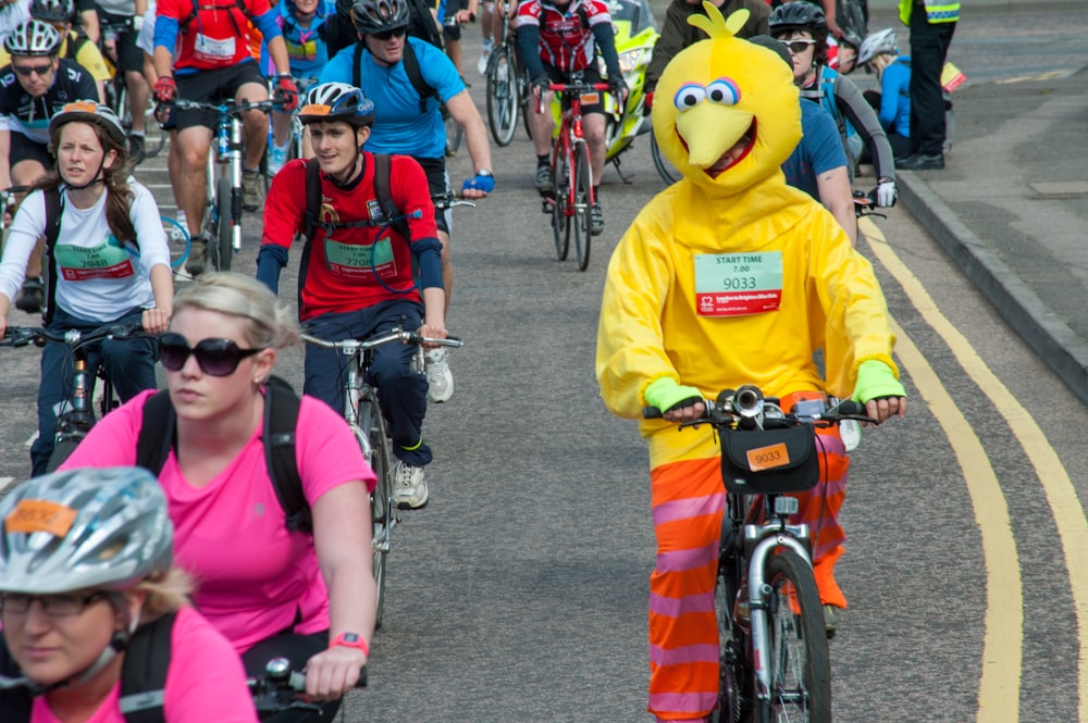 a group of people riding bikes down a street