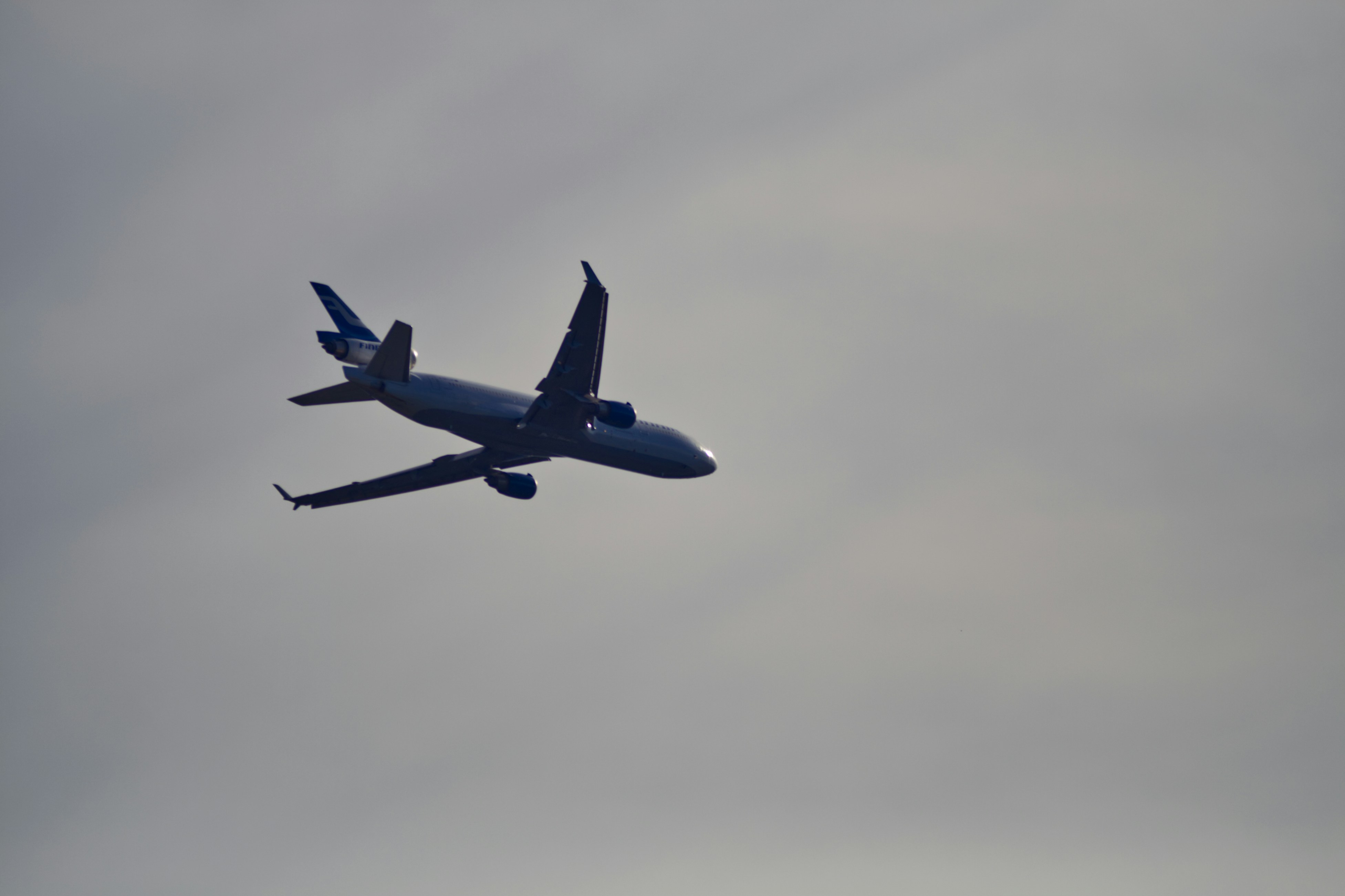 a large passenger jet flying through a cloudy sky