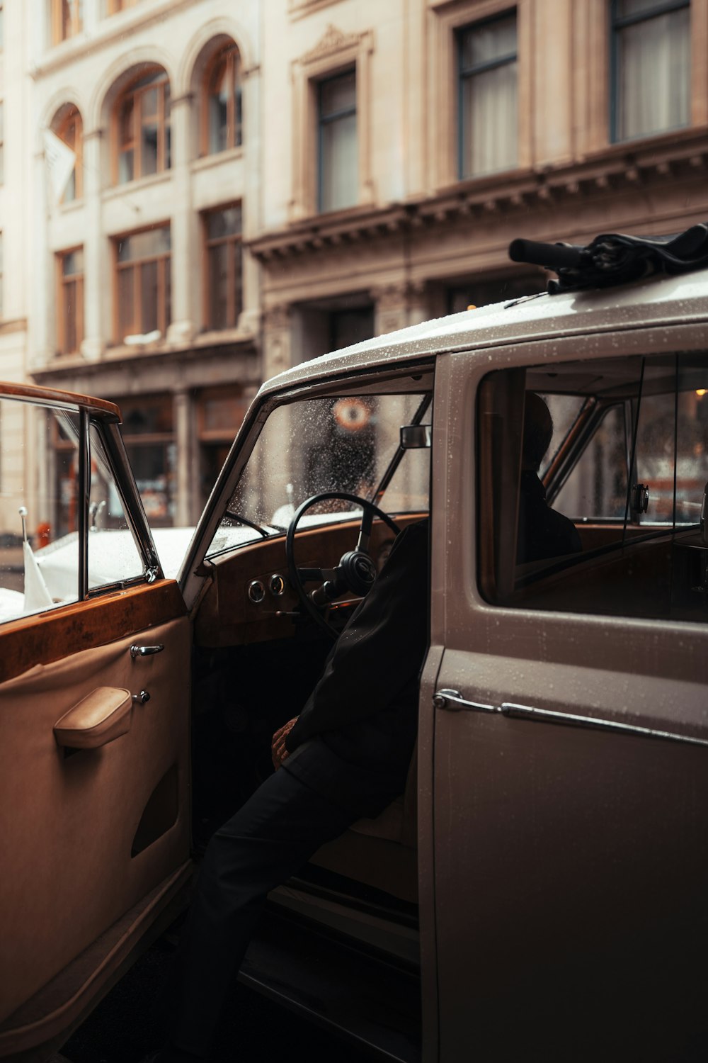 a man sitting in the driver's seat of a car