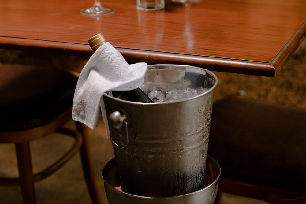 a metal bucket with a bottle of wine in it