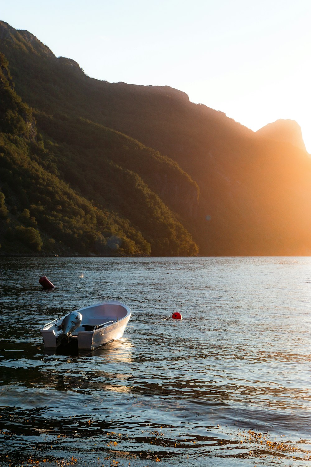 a small boat floating on top of a lake