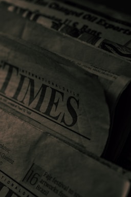 newspapers stacked on top of each other on a table