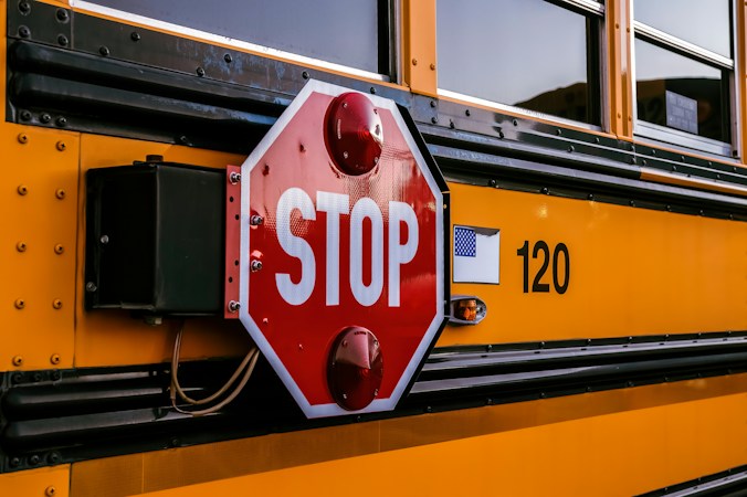 A stop sign extended from the side of a school bus, a reminder for Las Vegas drivers to slow down and stop near schools and students