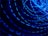 A series of bright blue light trails in circular motions against a dark background, creating a dynamic and energetic visual effect.