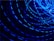 A series of bright blue light trails in circular motions against a dark background, creating a dynamic and energetic visual effect.