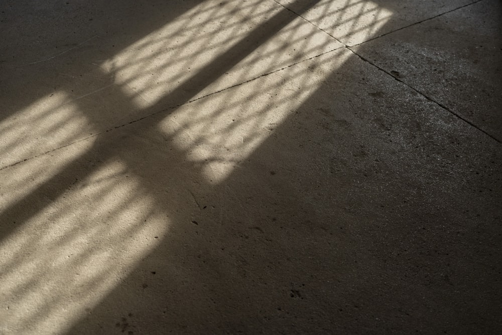 the shadow of a window on a concrete floor