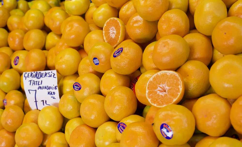 a pile of oranges for sale at a market