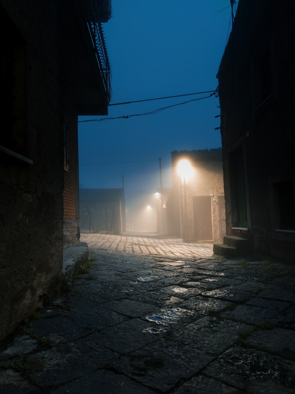 a dark alley way with a street light at night