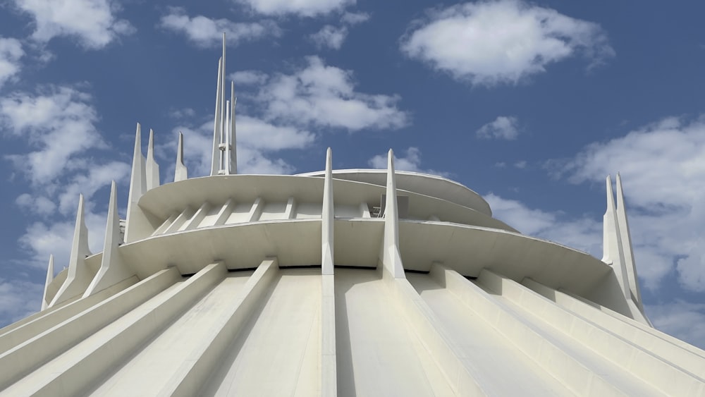 the top of a building under a cloudy blue sky