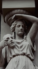 a statue of a woman with a hat on her head