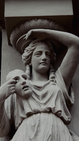 a statue of a woman with a hat on her head