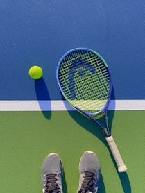 a tennis racket and a tennis ball on a court