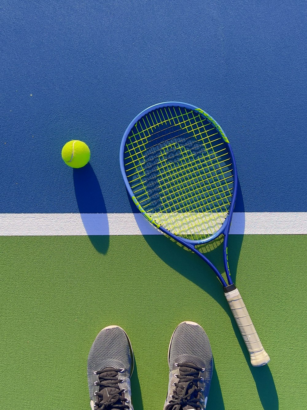 a tennis racket and a tennis ball on a court