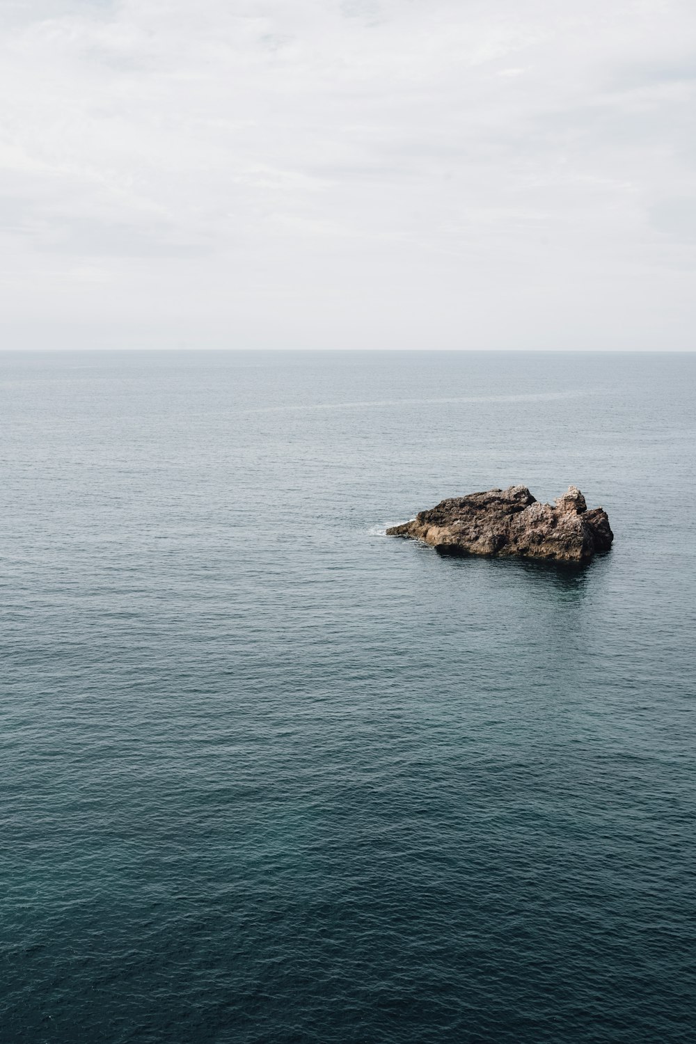 a rock out in the middle of the ocean