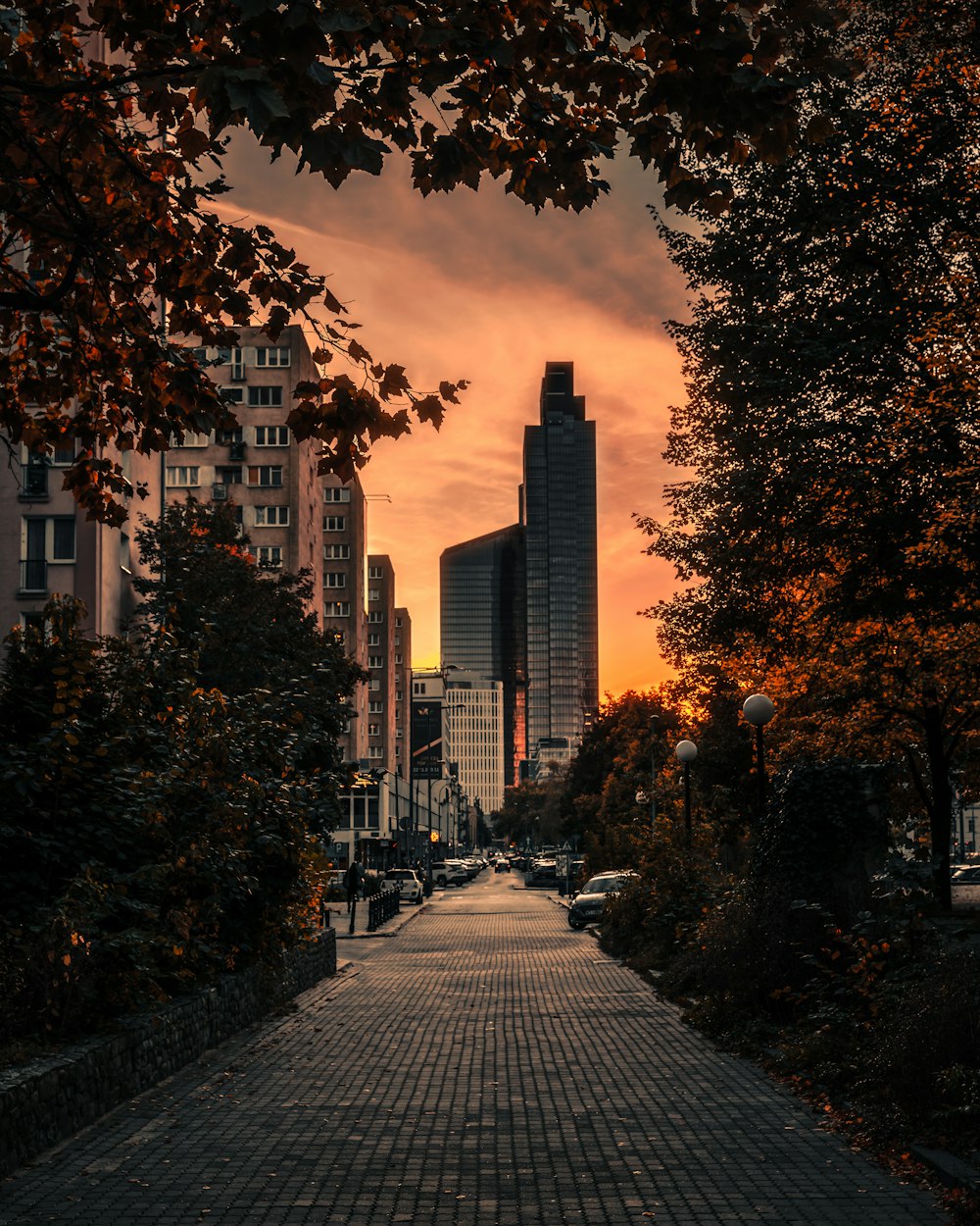 the sun is setting over a city street