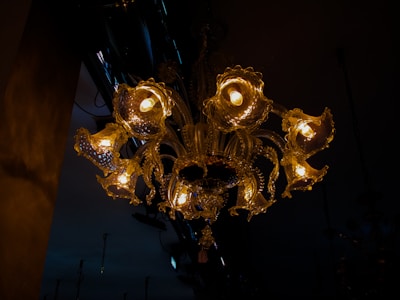 A stunning gold chandelier casting warm light over a modern Moroccan living room.