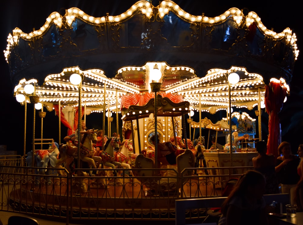 a merry go round at night with people on it