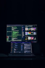 a laptop computer sitting on top of a desk