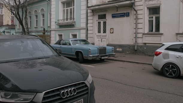 two cars parked on the side of the road