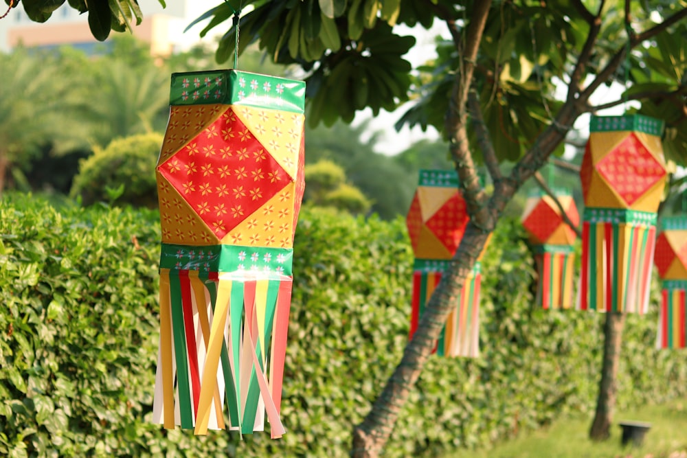 a row of colorful paper lanterns hanging from a tree