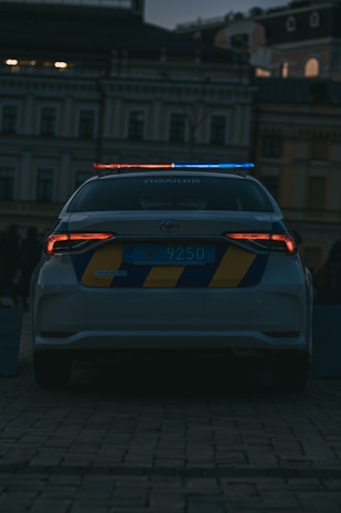 a police car parked in front of a building