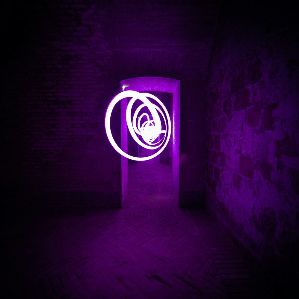 a purple light is shining in a dark room