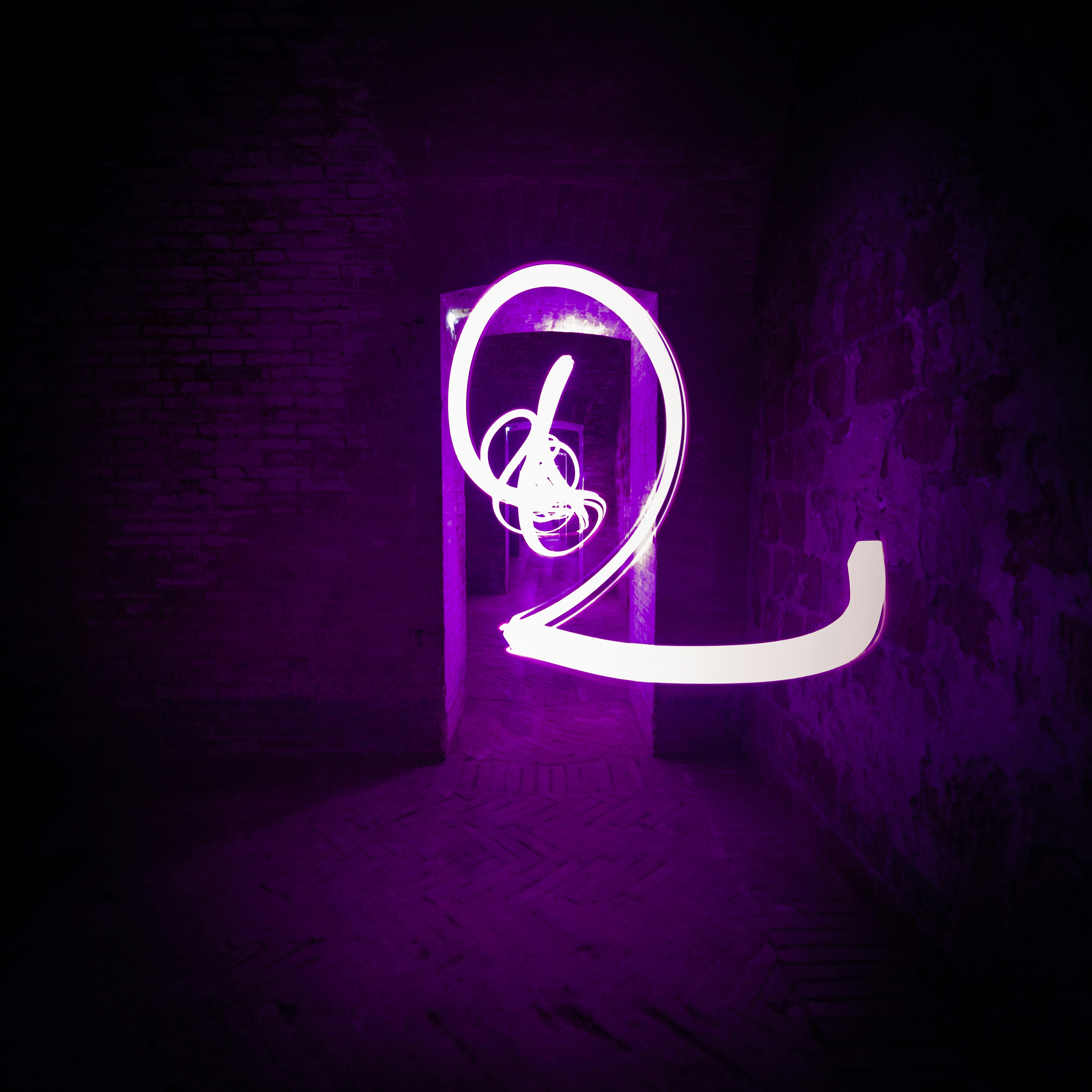 a purple light is shining in the dark