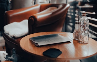 a wooden table topped with a bottle of wine