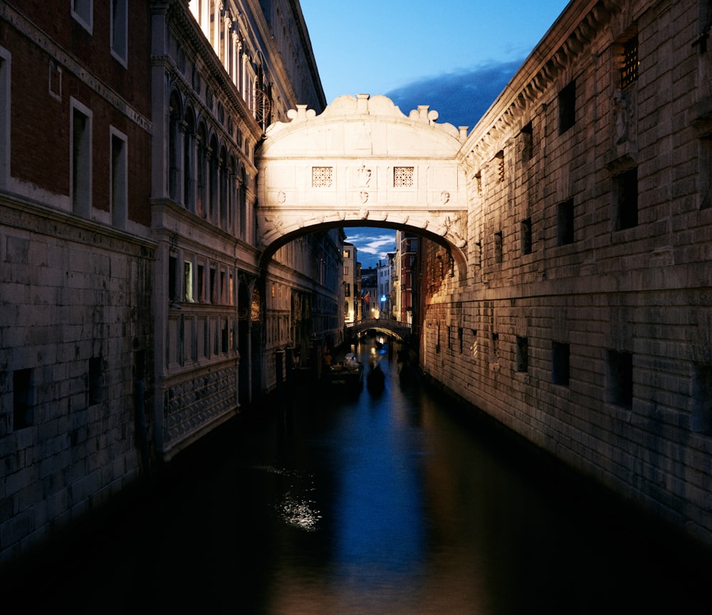 a narrow canal with a bridge in the middle of it