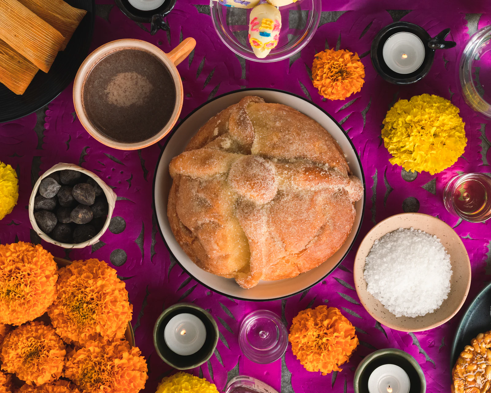 Mesa con panes y elementos de Día de Muertos