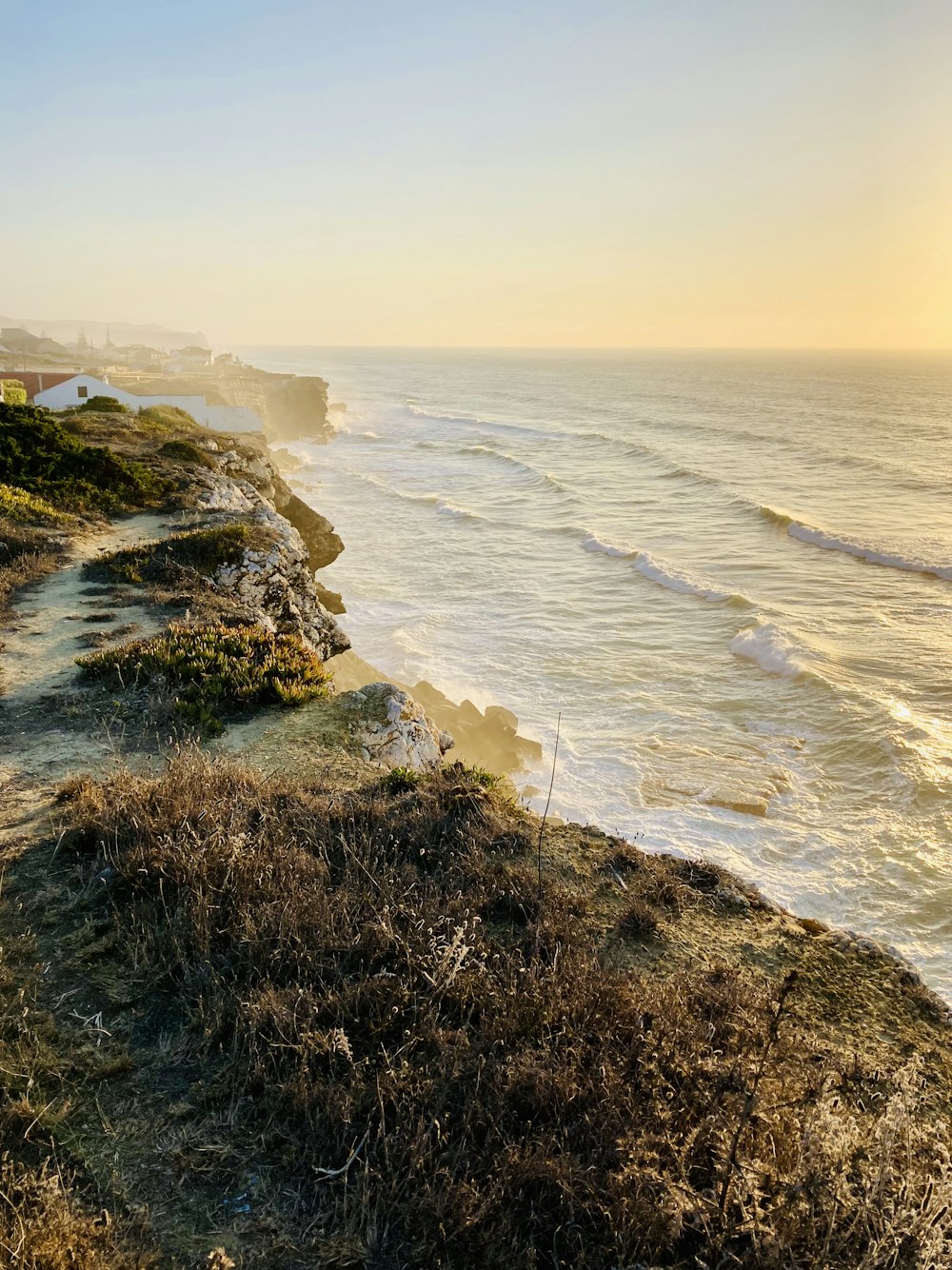 a view of the ocean from the top of a hill