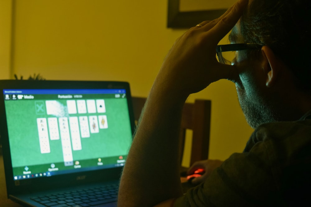 a man sitting in front of a laptop computer